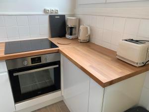 a kitchen with a counter top with a toaster and a blender at Les Pieds dans l'eau - Locations ISAHORA in Le Tréport
