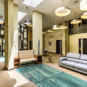 a lobby with a pool in the middle of a building at Urban Green Hotel & Suites in San José