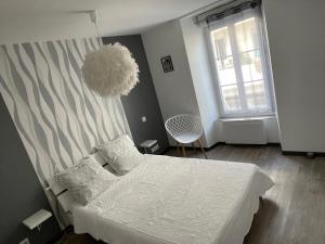 1 dormitorio con cama blanca y ventana en Cosy au coeur des 3 vallées, en Argelès-Gazost