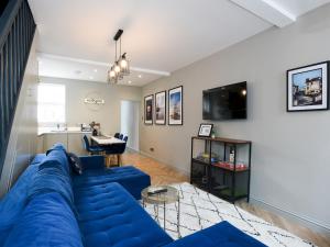 a living room with a blue couch and a table at Pass the Keys Newly refurbed 3Bed 2Bath house in Central Portsmouth in Portsmouth