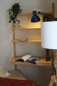 a book shelf with a computer on it with a lamp at B&B Palazzo de "Il Nuovo Duca Minimo" in Pescara