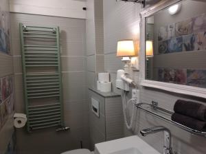 a bathroom with a toilet and a sink and a mirror at VRYE HEERLYKHEYD ( adults only ) studio 2 in Middelburg