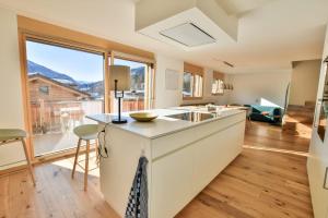 a kitchen with a sink and a large window at Milachra Penthouse in Fiesch