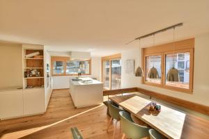 a kitchen and dining room with a table and chairs at Milachra Penthouse in Fiesch