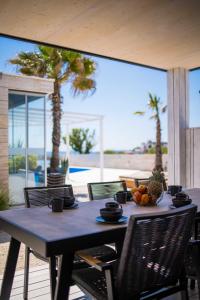 a table with a bowl of fruit on a patio at Arcadia Eco-Luxe Resort in Privlaka