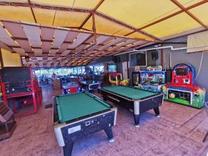 a room with two pool tables and other games at Sidari Waterpark in Sidari
