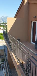 a balcony with a metal railing on a building at Apartments Scorpio in Kotor