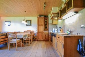 a kitchen with a table and a dining room at Weisshorn 24 in Riederalp