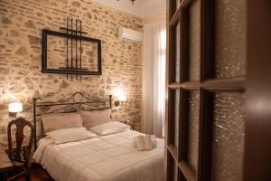 
a bedroom with a bed and a window at Beautiful City Suites in Athens
