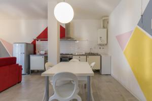 a small kitchen with a white table and chairs at I SOLI in Verona
