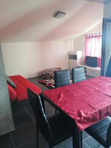 une salle à manger avec une table et des chaises rouges dans l'établissement Studio apartment in Funtana with balcony, air conditioning, WiFi, washing machine 4982-2, à Funtana