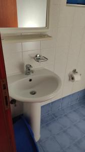 a bathroom with a white sink and a mirror at Galini Studios in Palaiochora