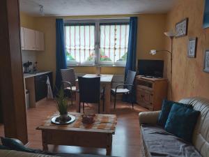 a living room with a couch and a table with a dining room at Ferienapartmenthaus am Rittertor in Stolberg