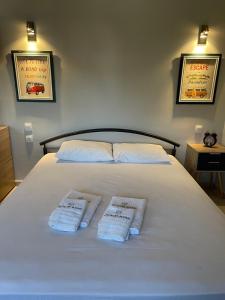 a large white bed with two towels on it at Q luxury rooms Perea center in Perea