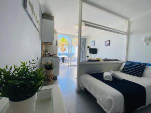 a bedroom with a bed with a large window at Beach Apartment 3 in Patalavaca