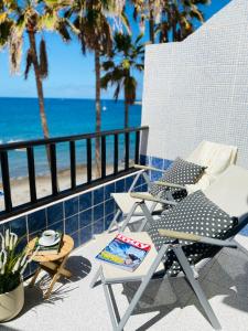 a patio with a table and chairs and the beach at Beach Apartment 3 in Patalavaca