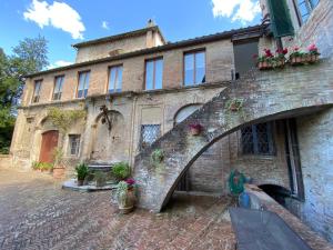 an old brick building with an archway in front of it at B&B Palazzo Bruchi in Siena