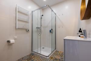 a glass shower in a bathroom with a sink at Apartamenty na wydmach in Łeba +123 photos