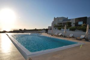 a swimming pool on the side of a building at Black Rock in Akrotiri