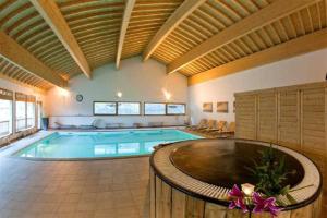 a large swimming pool in a large room at ORELLE VALLEE DE LA MAURIENNE in Orelle