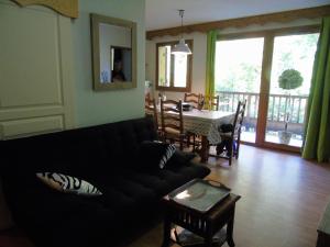 a living room with a couch and a table and a dining room at ORELLE VALLEE DE LA MAURIENNE in Orelle