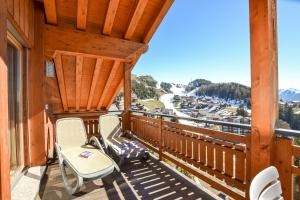 a balcony with chairs and a view of a mountain at Casa Arturo Penthouse in Riederalp