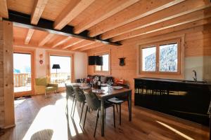 a dining room with a table and chairs at Hirschfluh Duplex in Riederalp