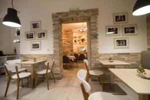 a restaurant with tables and chairs in a room at villa pergola in Trebinje