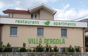 a building with a sign forrestaurant apartments villa ricoco at villa pergola in Trebinje