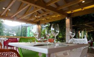 a white table with wine glasses on a patio at villa pergola in Trebinje