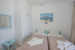 Postel nebo postele na pokoji v ubytování Spiros and Polyxeni Apartments Afionas