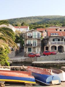 a group of boats sitting in the water in front of buildings at Studio Apartments Krasici in Tivat