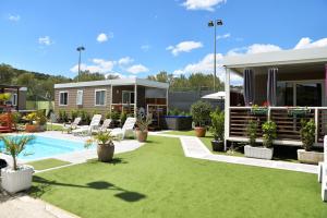 a house with a backyard with a pool and grass at Camping Matija in Betina