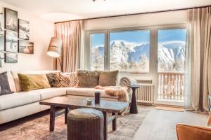 a living room with a couch and a table at Hollandia 18 in Riederalp