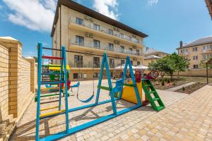 a playground in front of a building at Hotel Granada in Vityazevo
