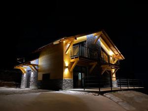 a building with a balcony on the side of it at night at Chalet Filipsky Deluxe in Ždiar