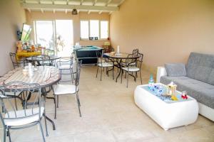 a living room with a couch and a table and chairs at B&B Li Fichi Alezio/Gallipoli in Alezio