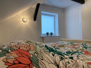 a bedroom with a bed with a floral bedspread at Ferienwohnung Spieker in Hamburg in Hamburg