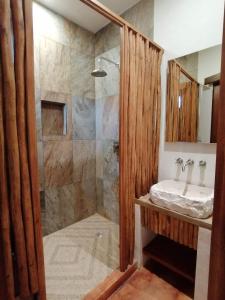 a bathroom with a shower and a sink at Casa Mech in Holbox Island