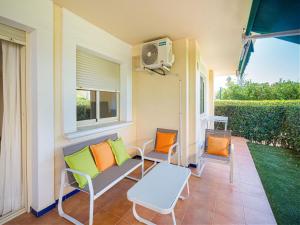 een veranda met stoelen, een tafel en verwarming bij Apartment with pool in Urb Medina del Sol in Denia