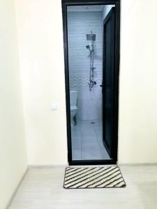 a bathroom with a shower with a glass door at Gurya in K'obulet'i