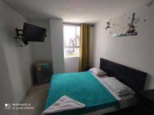 מיטה או מיטות בחדר ב-Hotel La Mar Cartagena