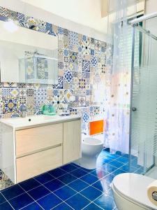 a bathroom with a toilet and a sink and a shower at Mille tramonti Agropoli sunset suite in Agropoli