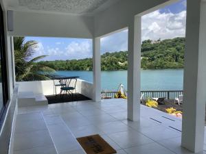a balcony with a view of a lake at Ridge Bay Chateau in Port Antonio