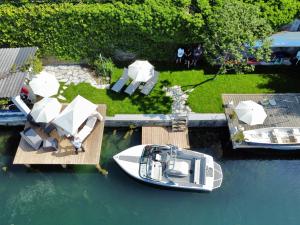 a boat is docked on a dock in the water at Hotel Nikolasch in Millstatt