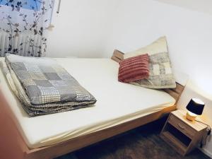 a bed with two pillows on top of it at Bleibe in Crailsheim