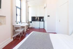 ein Schlafzimmer mit Bett und eine Küche mit Tisch in der Unterkunft ON Apartments - Center in Porto
