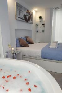 a room with two beds and a bath tub with hearts in it at Blue Horizon Luxury Apartment in Nerja