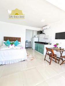 a large bedroom with a bed and a table at SUN7 in Morro de São Paulo