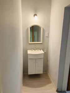 a bathroom with a white sink and a mirror at Complejo Nazareno in San Juan